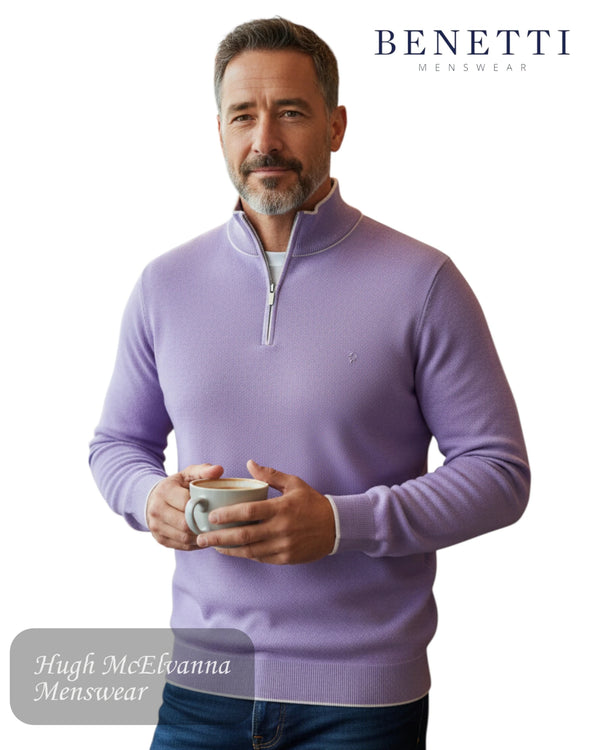 Man wearing a lilac quarter zip sweater holding a cup, with 'Benetti' branding in the corner.