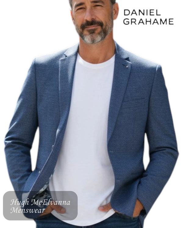 Man wearing a blue blazer over a white shirt with 'Daniel Grahame' branding.