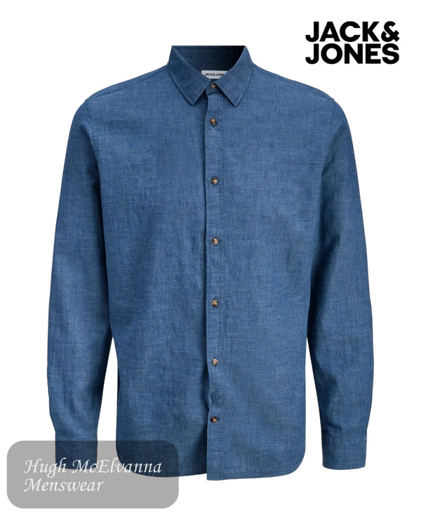 Blue shirt with button details on a white background, featuring Jack & Jones branding.