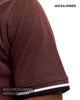 Detailed close-up of the short sleeve cuff on a Jack and Jones fire brick red polo shirt, featuring white and navy tipped detailing.