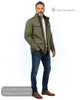 Full length studio model shot wearing Lino Clemente LIRA green jacket with cream knitwear, blue jeans, and brown leather boots