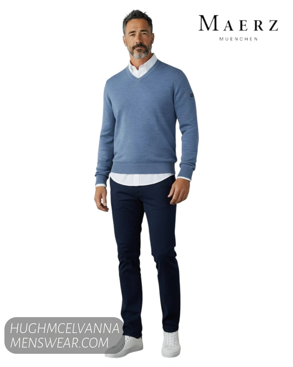 Full length model view wearing Maerz 490400 blue merino wool V neck jumper with white shirt and navy chinos
