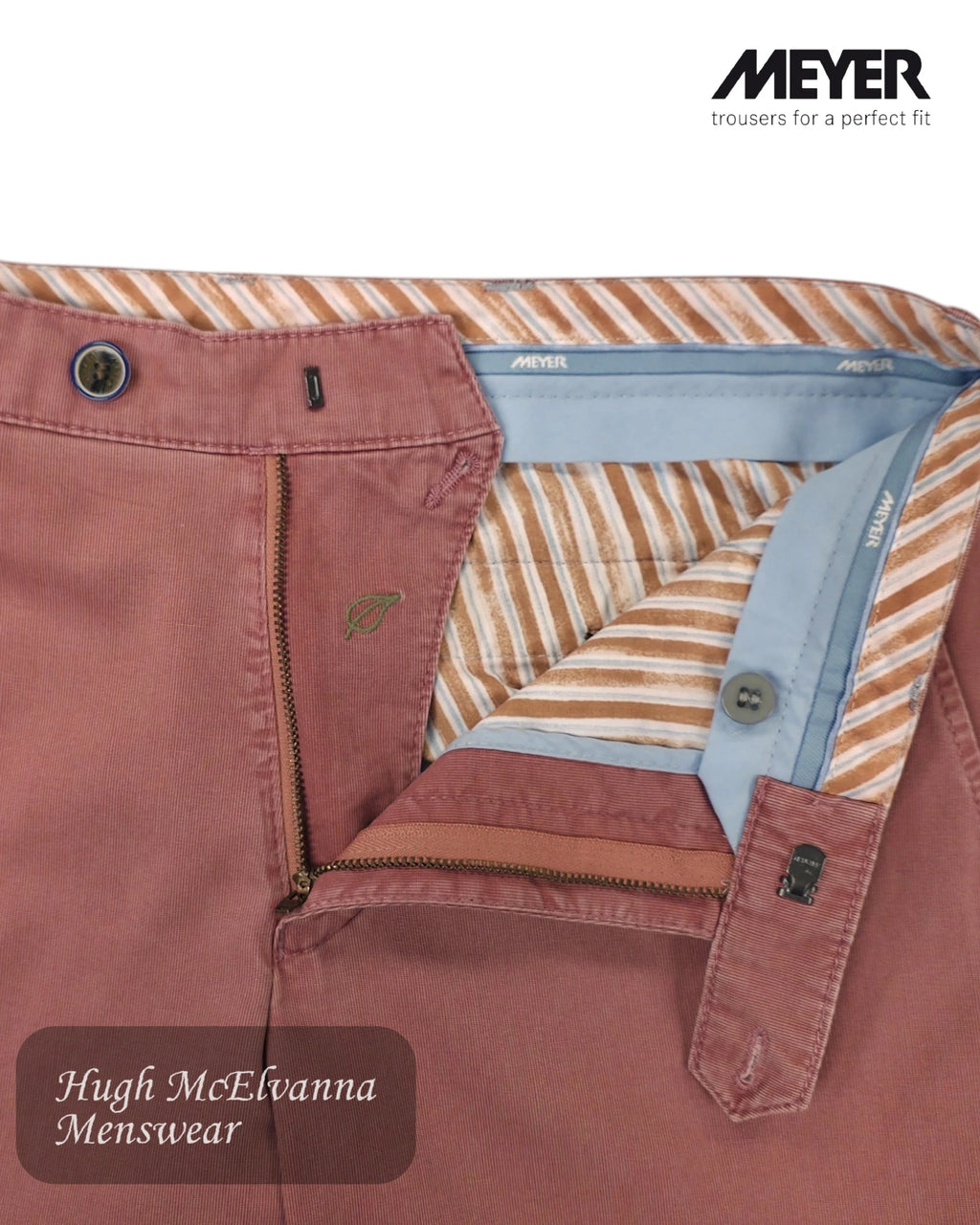 Close-up of a red trouser with striped lining and visible brand logo Meyer