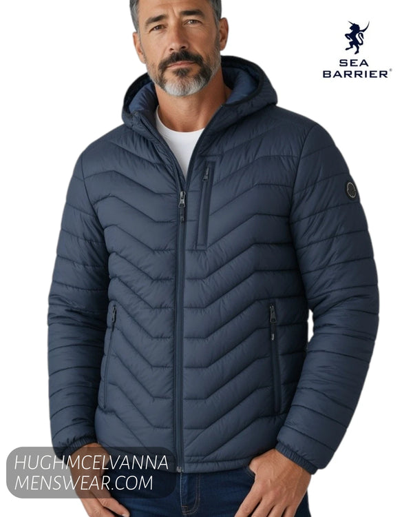 Close up portrait view of model wearing Sea Barrier FLORIANO navy chevron puffer jacket with hood