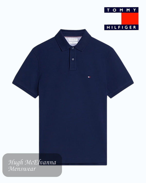 Navy blue polo shirt with Tommy Hilfiger logo on a white background