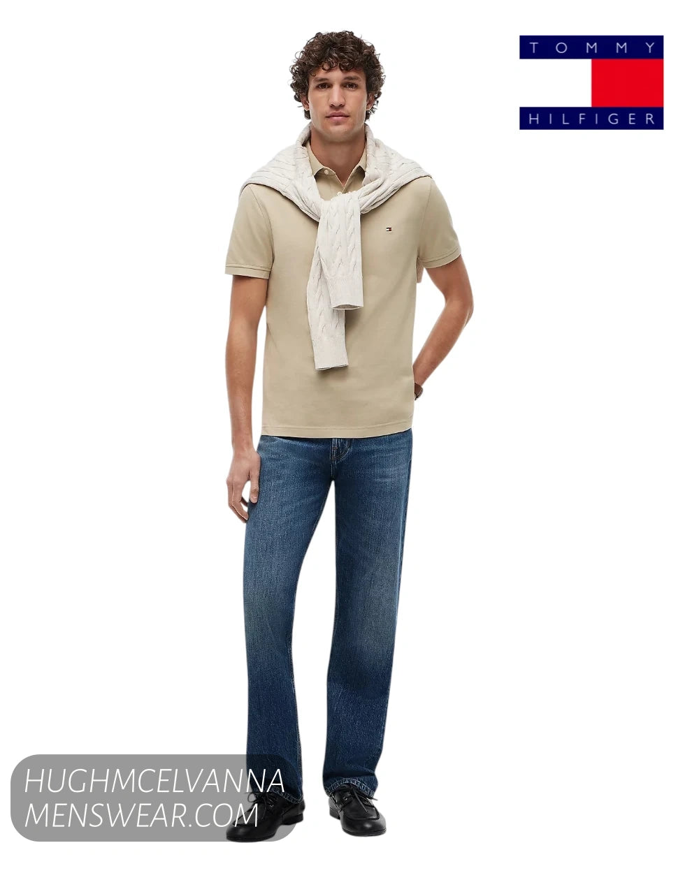Full length model view wearing Tommy Hilfiger 1985 Sandalwood polo shirt with knitwear over shoulders and blue jeans