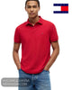 Front studio view of model wearing Tommy Hilfiger Medium Red regular fit polo shirt with hands in pockets