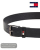 Angled close up view of Tommy Jeans black leather belt showing enamel flag badge on loop