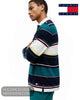 Side profile view of model wearing Tommy Jeans rugby shirt showing stepped hem and flag badge