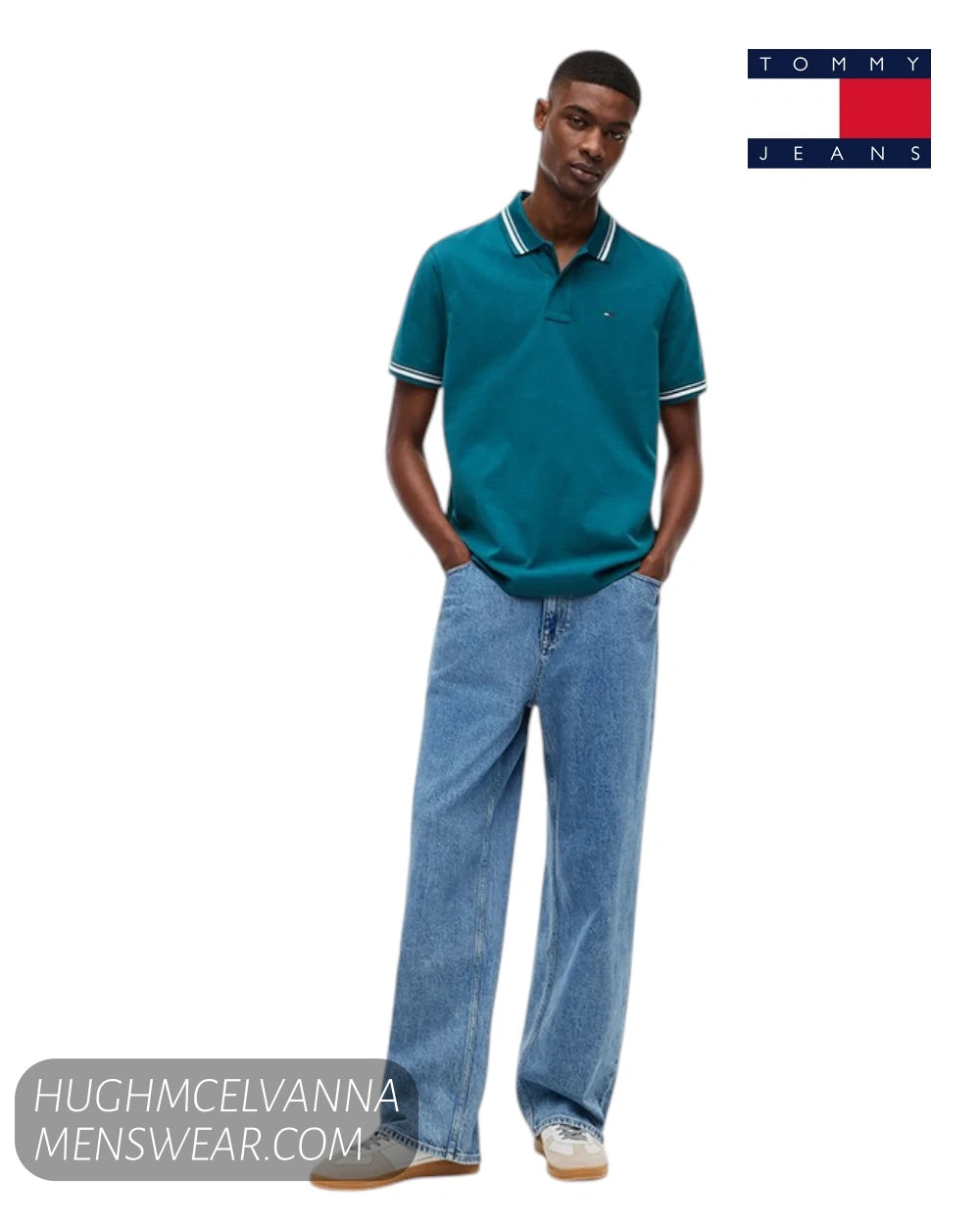 Full length studio model shot wearing Tommy Jeans Polar Teal tipped polo shirt with light wash jeans and retro trainers