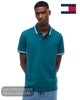 Front view of model wearing Tommy Jeans Polar Teal short sleeve polo shirt with hands behind back