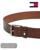 Angled close up view of Tommy Jeans winter cognac brown leather belt showing flag badge detail