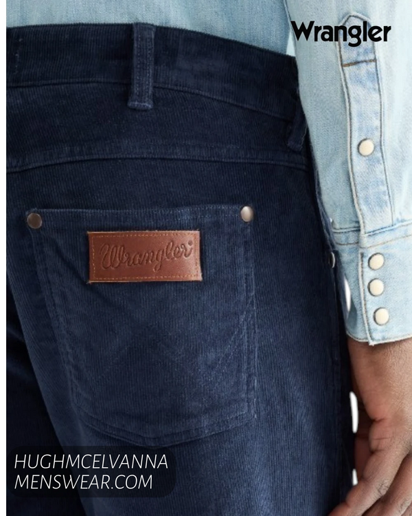 Rear pocket close up on Wrangler mood indigo cords showing iconic brown leather logo patch and W stitching