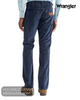 Full rear view of model wearing Wrangler Greensboro mood indigo blue straight leg cord trousers