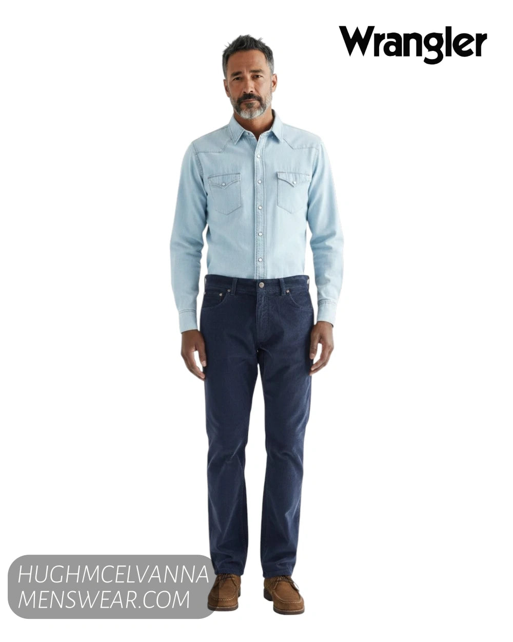 Full length model view wearing Wrangler Greensboro mood indigo cord jeans with light blue denim shirt and brown shoes
