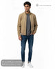 Full length studio model shot wearing Lino Clemente URAL tan jacket with blue jeans and white trainers
