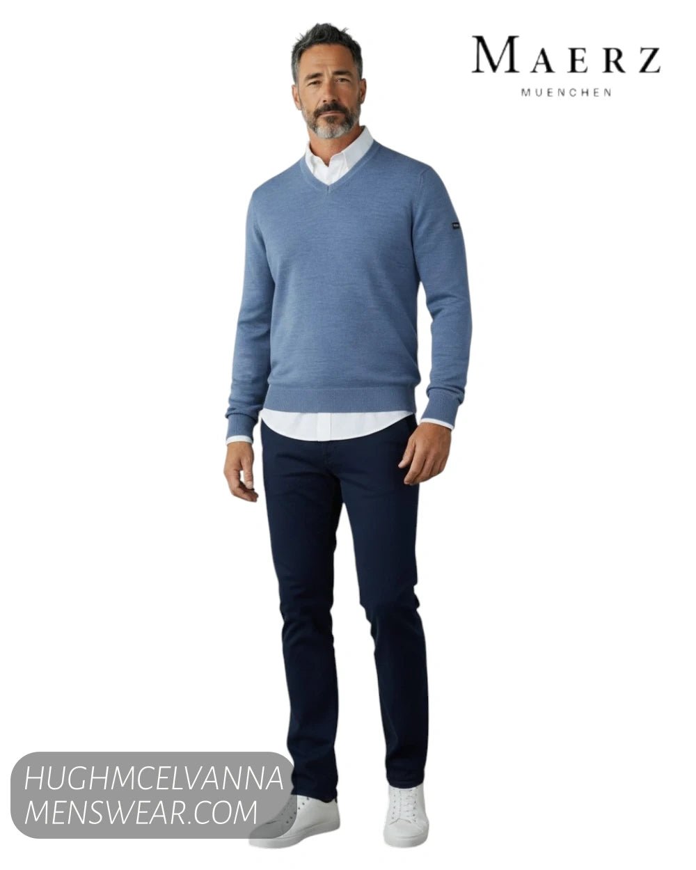 Full length model view wearing Maerz 490400 blue merino wool V neck jumper with white shirt and navy chinos