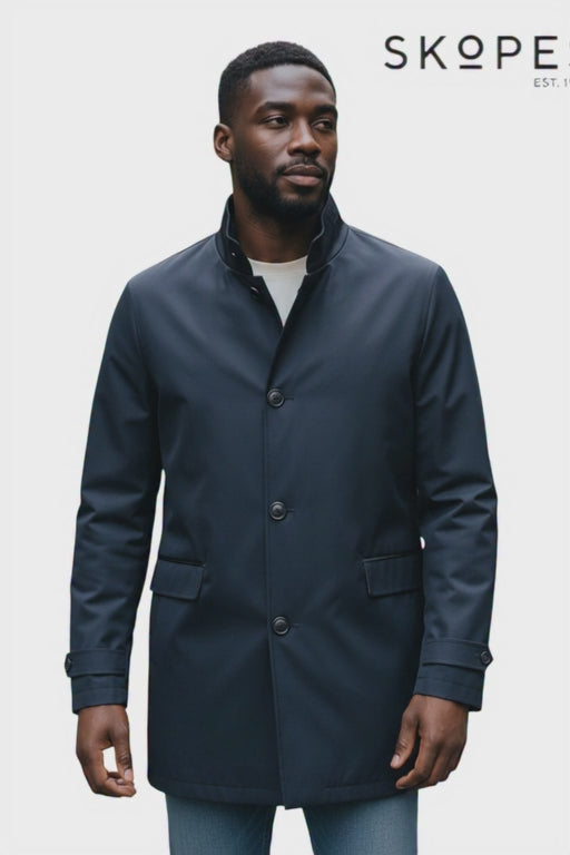 Model wearing a navy rain coat by skopes in style MITCHAM