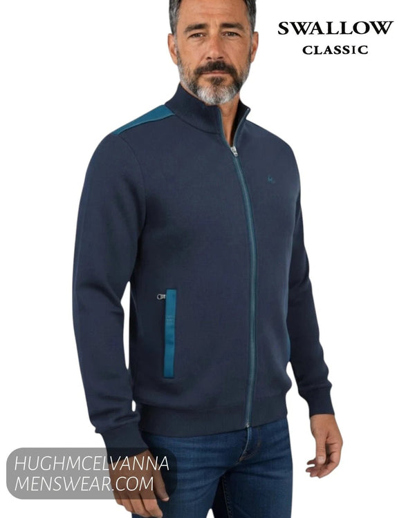 Close up front view of male model wearing Swallow Palco navy zip-up knit jacket showing contrast teal shoulder trim