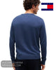 Rear view of male model wearing Tommy Hilfiger blue knit pullover showing clean back yoke and ribbed hem