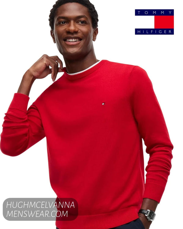 Smiling male model wearing Tommy Hilfiger red fine knit jumper showing regular fit profile