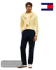 Full length model view wearing Tommy Hilfiger Light Daffodil yellow jumper with navy trousers and white trainers