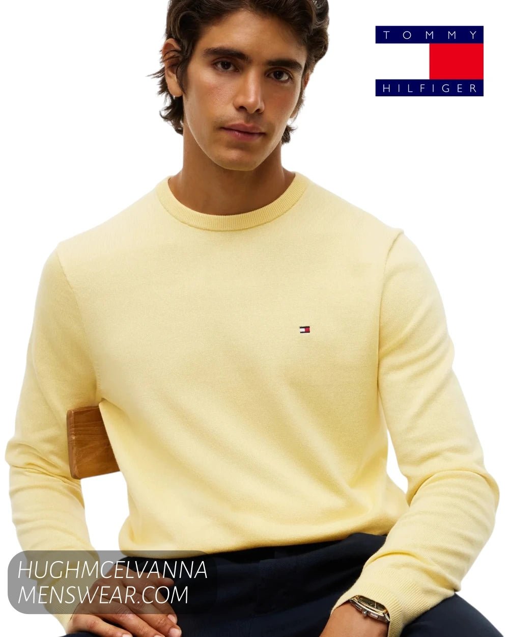 Seated view of model wearing Tommy Hilfiger Light Daffodil cotton crew neck pullover showing regular fit