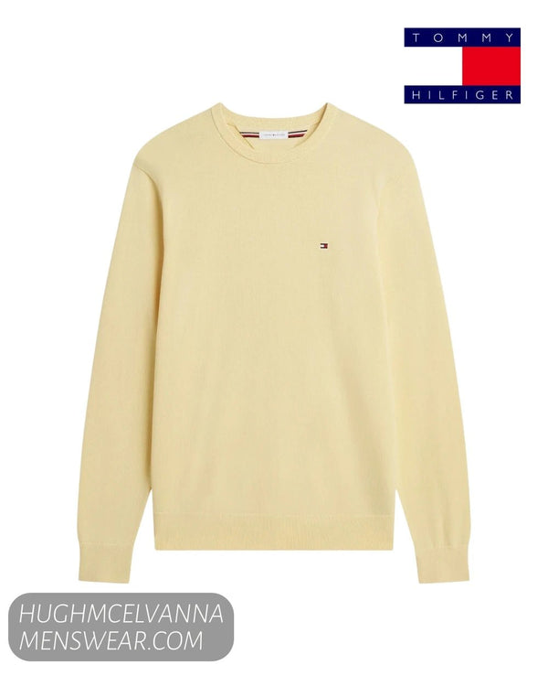 Flat lay studio display of Tommy Hilfiger MW0MW39999ZFD Light Daffodil cotton jumper with embroidered chest flag