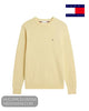 Flat lay studio display of Tommy Hilfiger MW0MW39999ZFD Light Daffodil cotton jumper with embroidered chest flag