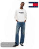Full length model view wearing Tommy Jeans ancient white sweatshirt with relaxed blue denim jeans and navy trainers