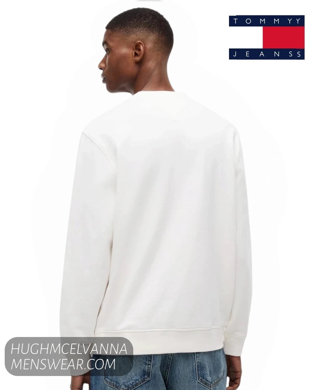 Rear view of male model wearing Tommy Jeans white crew neck sweatshirt showing back shoulder seam and ribbed hem
