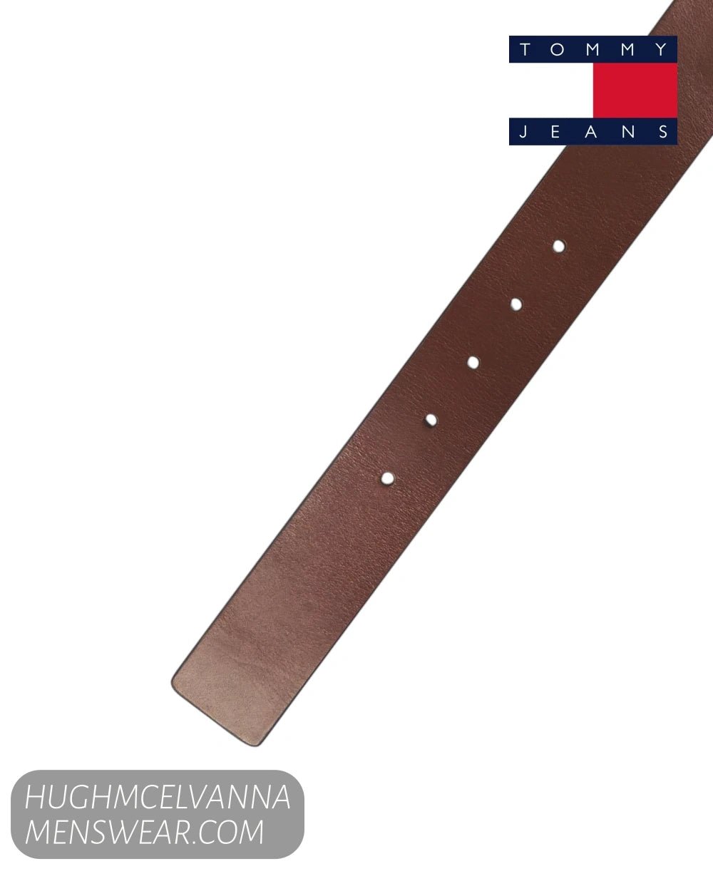 A brown leather belt strap shown diagonally on a white background, featuring a Tommy Jeans logo in the top right corner.