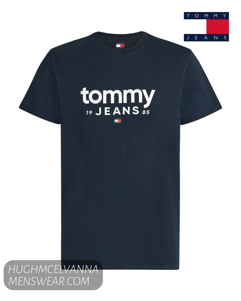 Flat lay product display of Tommy Jeans navy t-shirt featuring white 1985 logo print and flag emblem