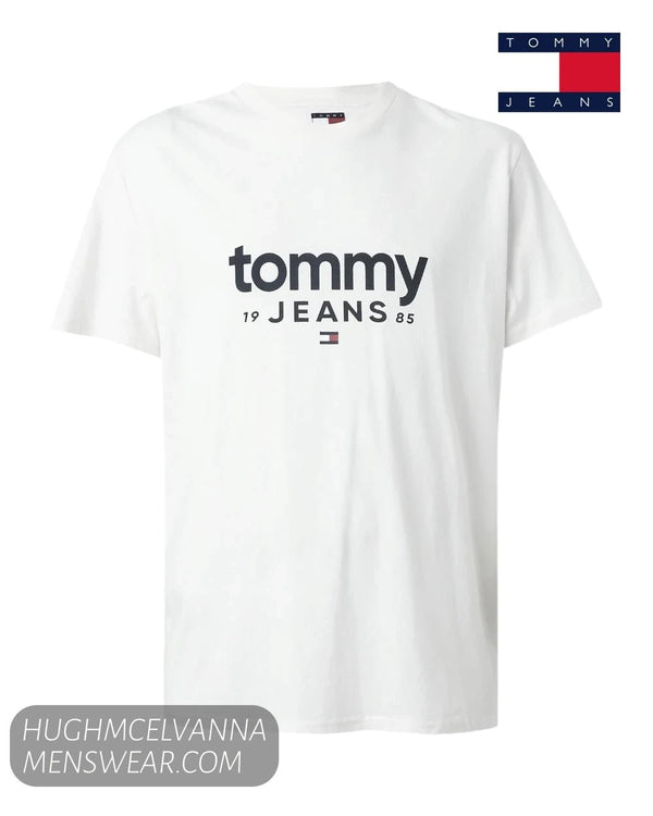 Flat lay product display of Tommy Jeans white t-shirt featuring navy 1985 logo print and flag detail