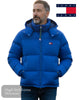 Man wearing a blue puffer jacket with Tommy Jeans logo on a white background