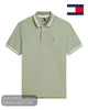 Studio flat lay display of Tommy Jeans men's tipped polo shirt DM0DM22709PMO in Spring Olive