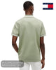 Rear view of male model wearing Tommy Jeans Spring Olive tipped polo shirt with white trousers