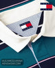 Close up detail of Tommy Jeans white twill rugby collar, button placket, and pinstripe inner neckband