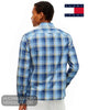 A man wearing a blue plaid long-sleeve shirt by Tommy Jeans, shown from the back against a white background.