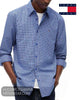 Standing three-quarter view of model wearing Tommy Jeans blue check long sleeve shirt with hands in pockets