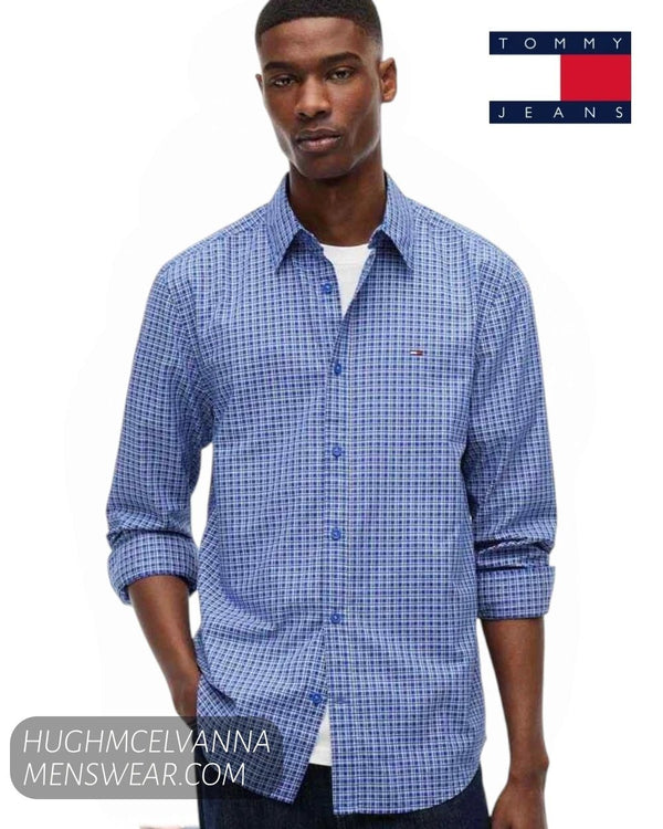 Front view of model wearing Tommy Jeans Providence Blue check shirt with sleeves rolled up over white t-shirt