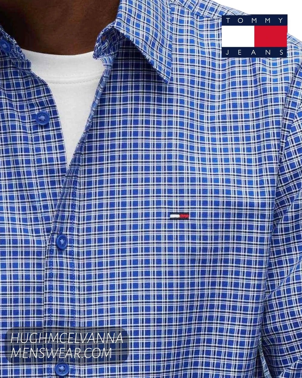 Close up detail of Tommy Jeans Providence Blue grid check cotton fabric, blue buttons, and embroidered chest flag badge