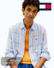 Model wearing Tommy Jeans relaxed fit linen shirt with blue and orange checkered pattern and classic collar. DM0DM22758-C3Q